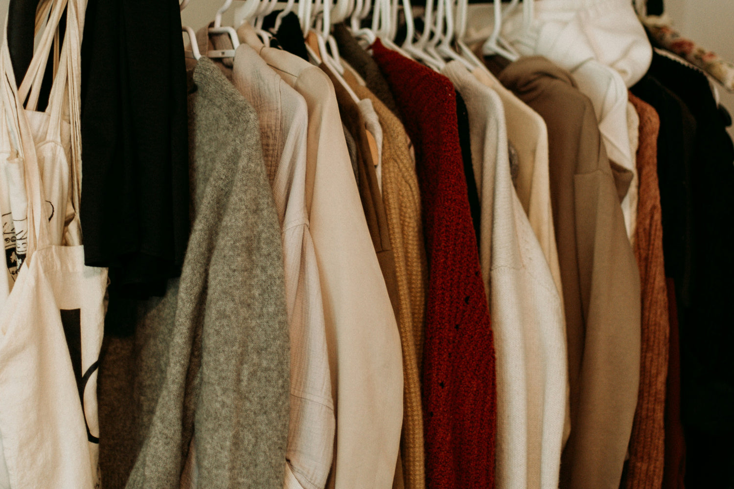 Earth-toned clothes hanging on a clothing rack